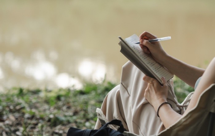 woman sitting and writing poems